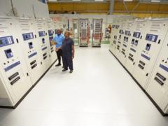 ACTOM P&C staff Vusi Dlamini (left) and David Vilakazi inspect protection and control panels during factory acceptance testing for the Sekelduin digital substation project.